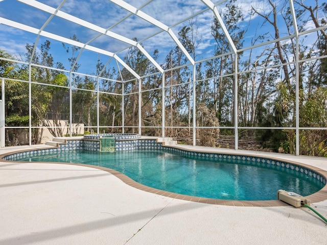 view of swimming pool with glass enclosure and a patio