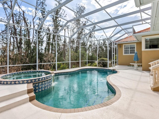 view of pool featuring an in ground hot tub, a patio area, and a lanai