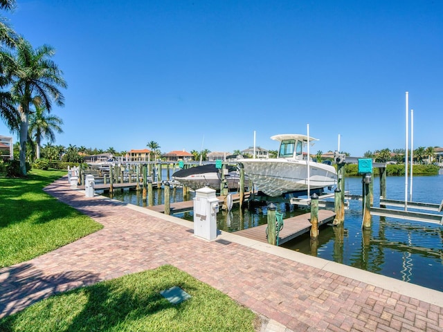 view of dock featuring a water view and a lawn