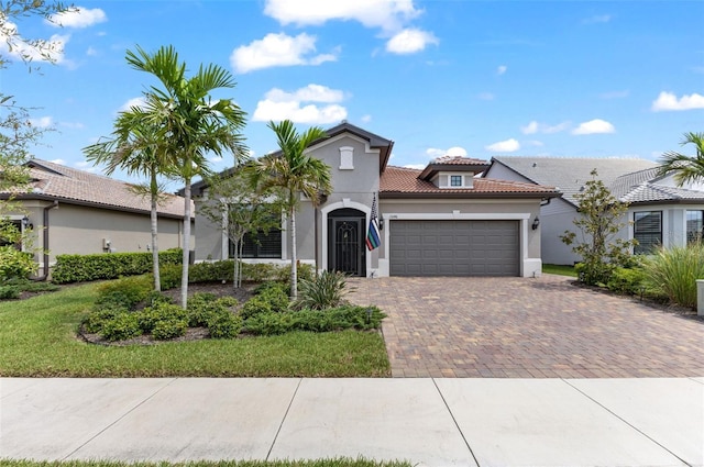 mediterranean / spanish home with a front lawn and a garage