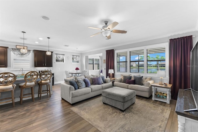 living room featuring ceiling fan, ornamental molding, and dark hardwood / wood-style floors