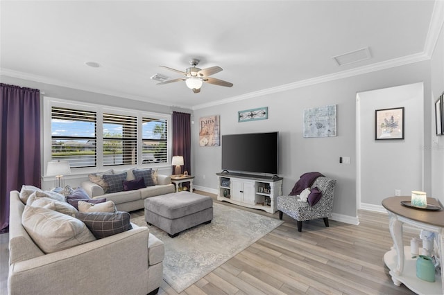 living room featuring ornamental molding, light wood-type flooring, and ceiling fan