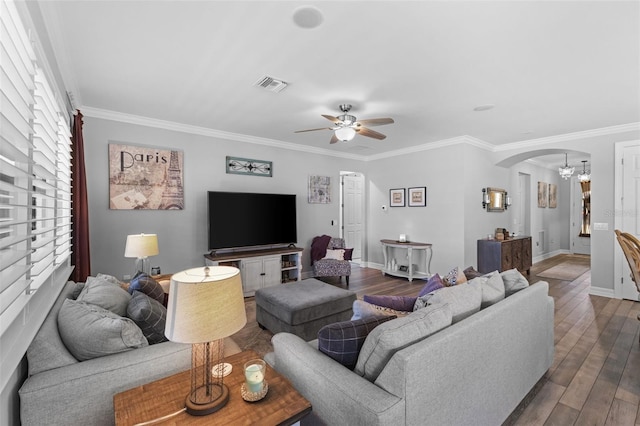 living room with ceiling fan with notable chandelier, hardwood / wood-style flooring, and crown molding