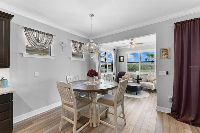 dining room featuring ceiling fan with notable chandelier, ornamental molding, and light hardwood / wood-style floors