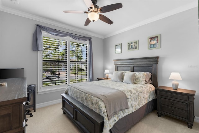 carpeted bedroom featuring ceiling fan and crown molding