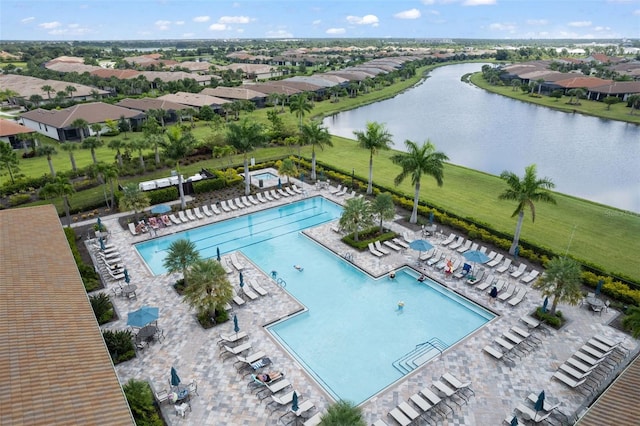 view of swimming pool with a patio and a water view