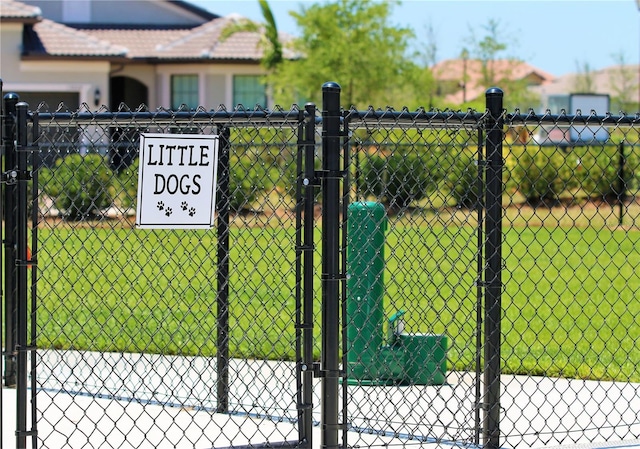 view of gate featuring a yard