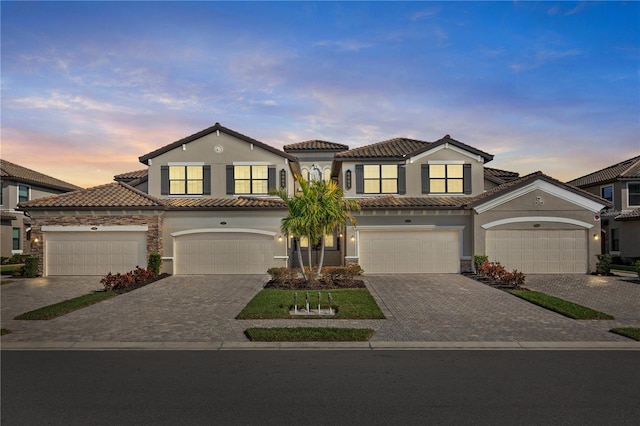 mediterranean / spanish-style home with a garage