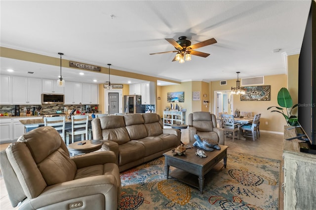 living room with ceiling fan and light tile patterned flooring