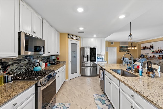 kitchen featuring sink, white cabinets, and appliances with stainless steel finishes