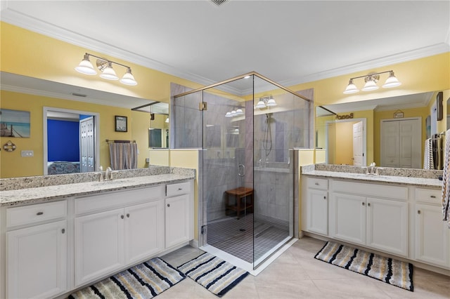 bathroom featuring vanity, ornamental molding, tile patterned floors, and an enclosed shower