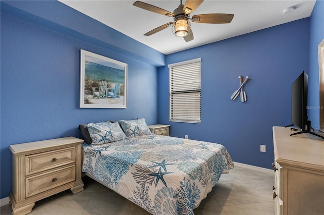 tiled bedroom featuring ceiling fan