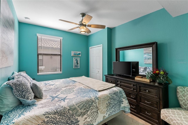 bedroom featuring ceiling fan and a closet