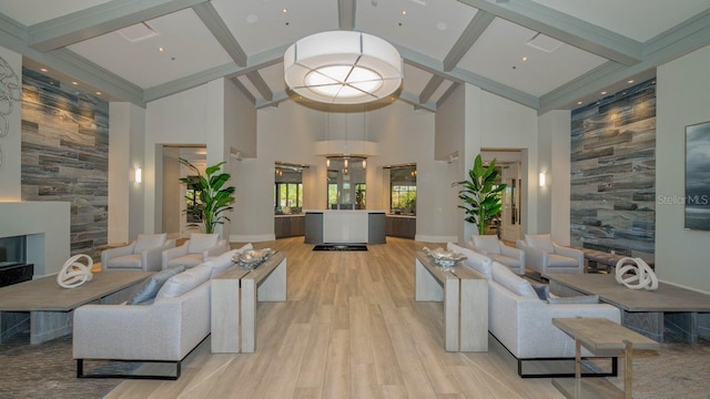 living room with high vaulted ceiling, a large fireplace, and light hardwood / wood-style flooring