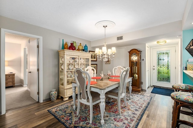 dining room with an inviting chandelier and hardwood / wood-style floors