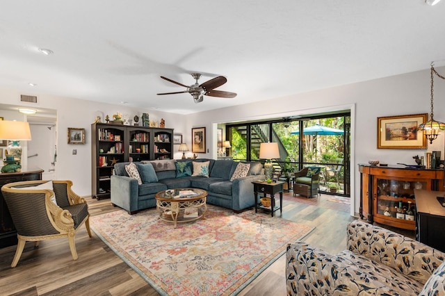 living room with hardwood / wood-style flooring and ceiling fan