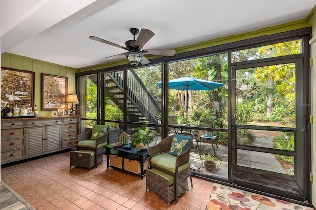 sunroom featuring ceiling fan and a healthy amount of sunlight