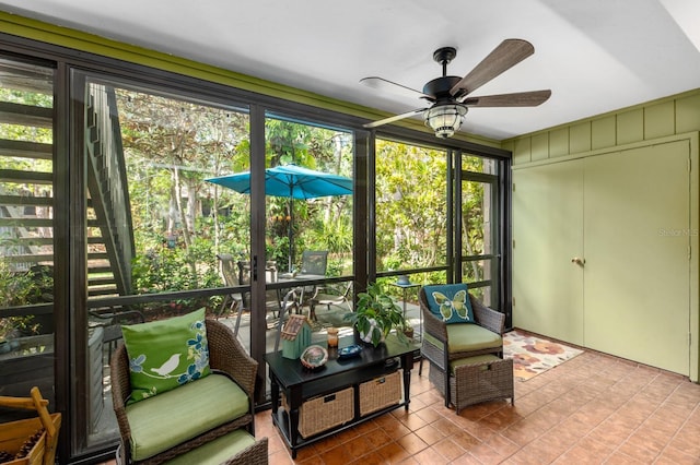 sunroom / solarium featuring ceiling fan