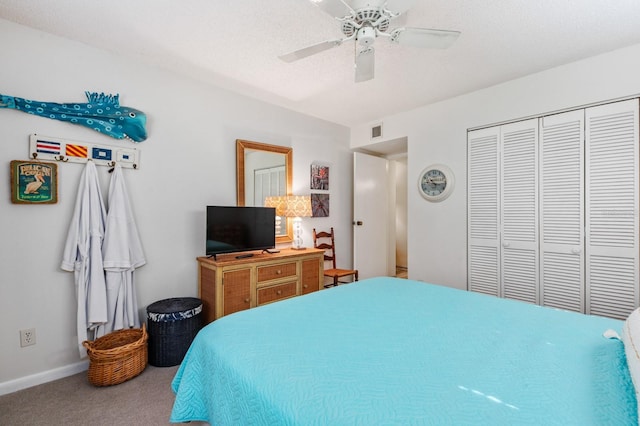 carpeted bedroom featuring a closet, ceiling fan, and a textured ceiling