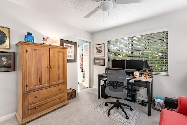 carpeted home office with a textured ceiling, ceiling fan, and a wealth of natural light