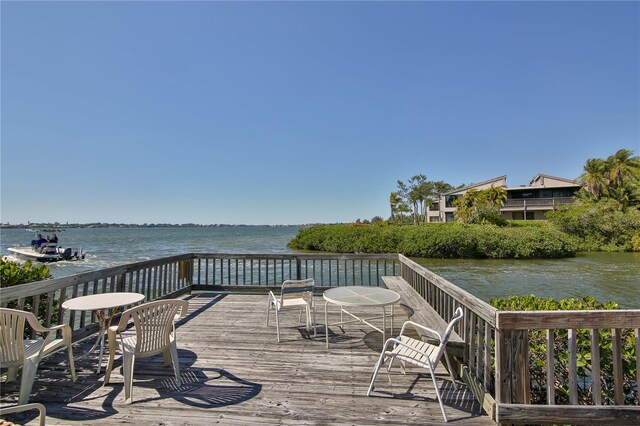 wooden terrace featuring a water view