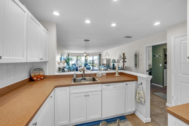 kitchen featuring decorative light fixtures, dishwasher, white cabinetry, and sink