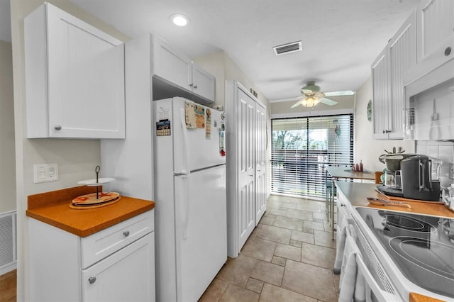 kitchen with ceiling fan, white appliances, and white cabinetry