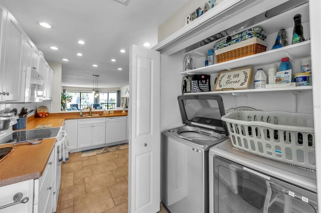 laundry room with washing machine and dryer and sink