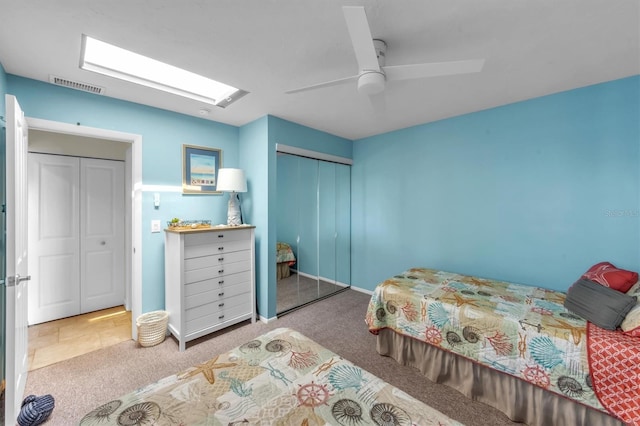 carpeted bedroom featuring ceiling fan and a closet