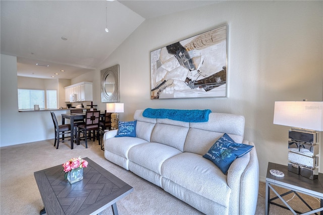 carpeted living room featuring lofted ceiling