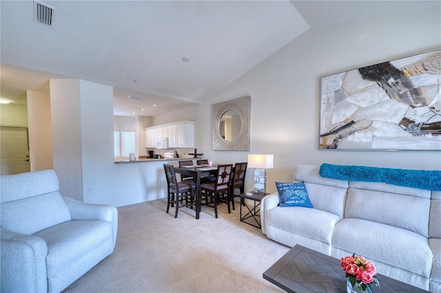 living room featuring light carpet and vaulted ceiling