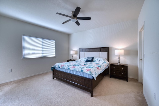 bedroom featuring ceiling fan and light carpet