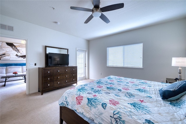 bedroom featuring ceiling fan and light carpet