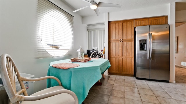 tiled dining room with ceiling fan