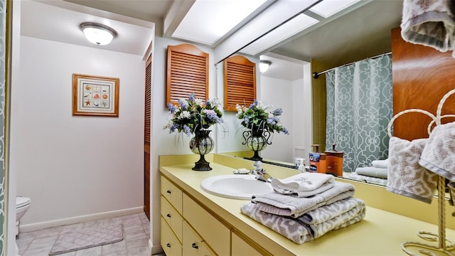 bathroom featuring toilet, tile patterned floors, and vanity