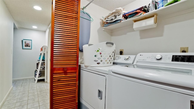 laundry area featuring a textured ceiling and washing machine and clothes dryer