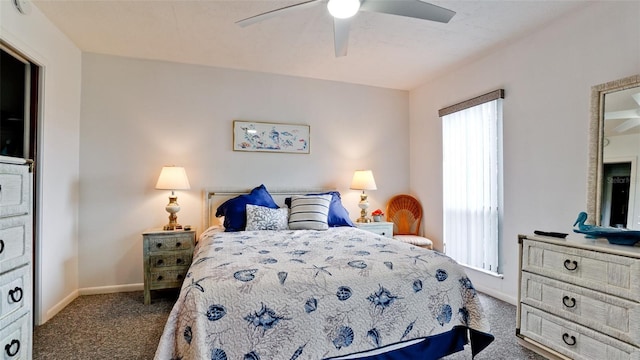 bedroom with ceiling fan and dark colored carpet