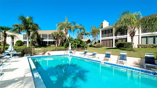 view of pool featuring a patio area and a lawn