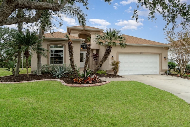 mediterranean / spanish house featuring a front lawn and a garage