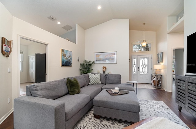 living room featuring high vaulted ceiling and hardwood / wood-style floors