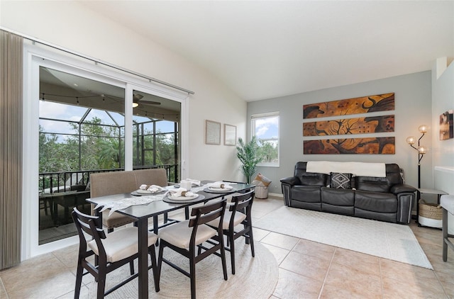 dining room with lofted ceiling and light tile patterned flooring