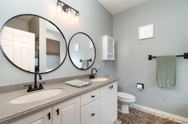 bathroom with toilet and vanity