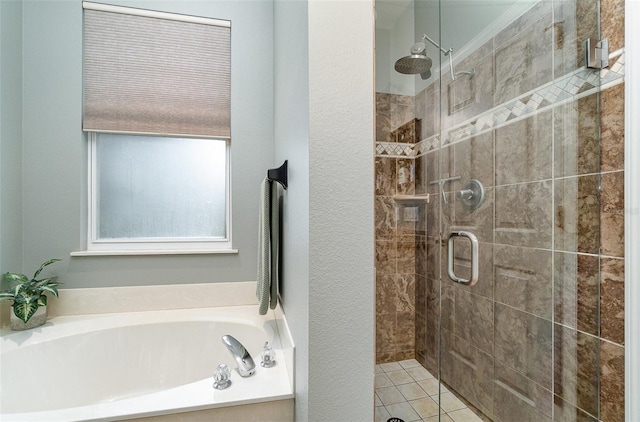 bathroom with tile patterned flooring and independent shower and bath