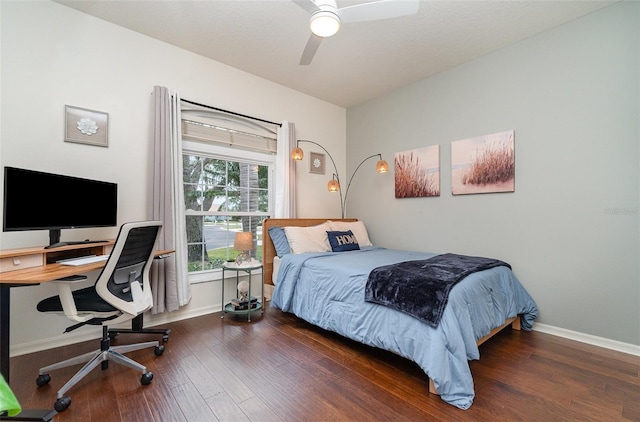 bedroom with ceiling fan and dark wood-type flooring