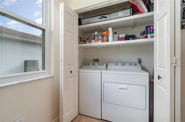 washroom with separate washer and dryer and light tile patterned floors