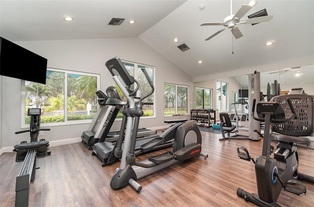 gym featuring vaulted ceiling, hardwood / wood-style flooring, and ceiling fan