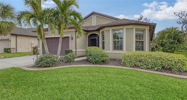 view of front of home with a front lawn and a garage