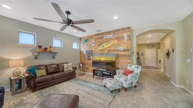 tiled living room with ceiling fan