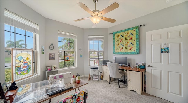 carpeted office space featuring ceiling fan