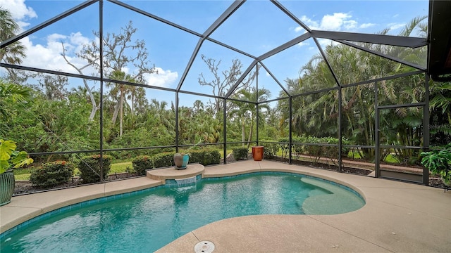 view of swimming pool featuring a patio area and a lanai